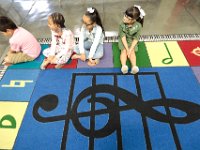 John B. Devalles elementary school second grader sit down on a musically themed rug, as they prepare for their first music class, as students across New Bedford return to school.  [ PETER PEREIRA/THE STANDARD-TIMES/SCMG ]